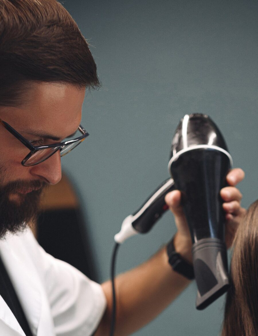 Barber styling a client after the cut